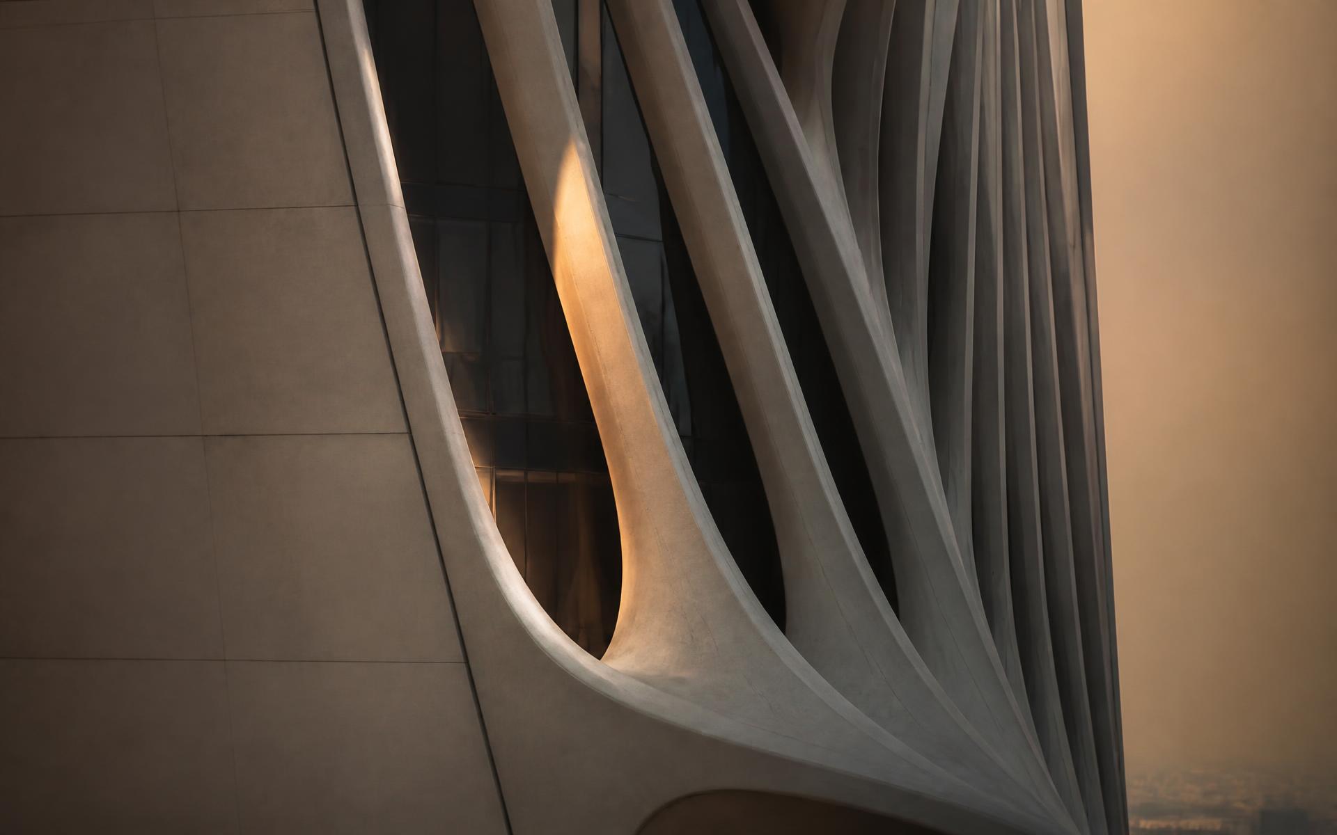Sculptural facade of a modern Dubai tower at dusk
